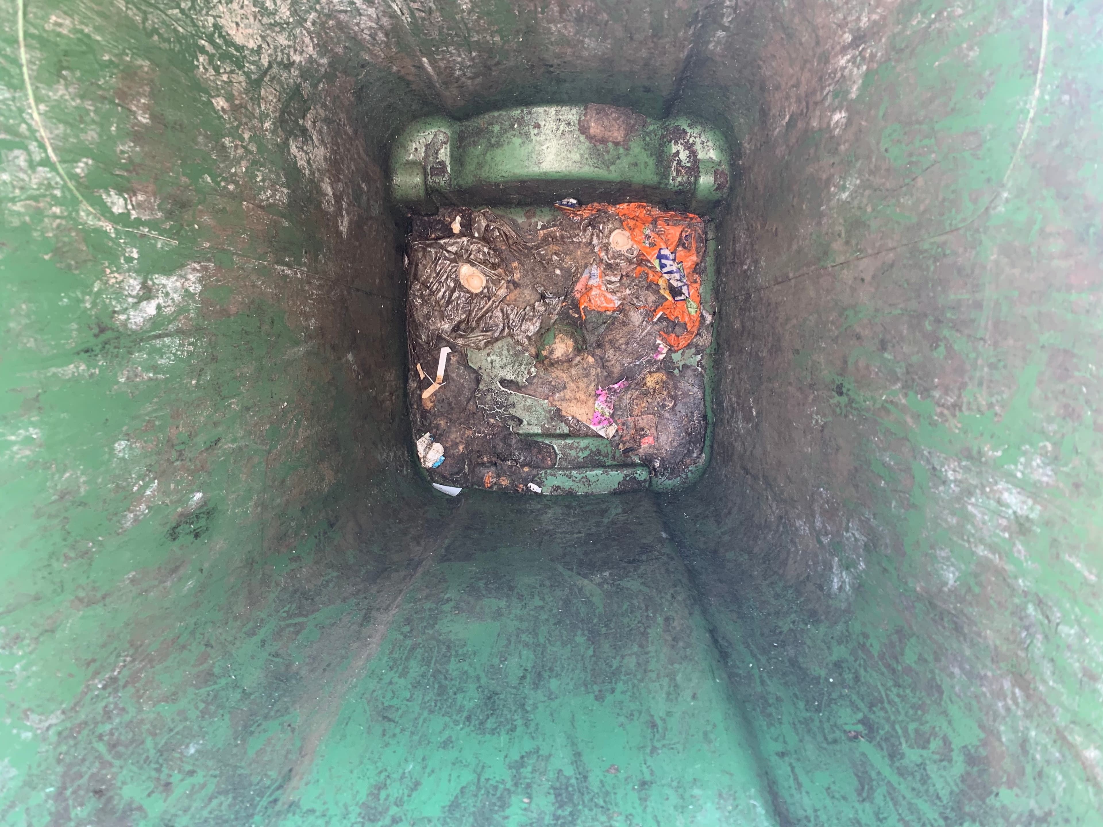 A dirty wheelie bin interior before cleaning